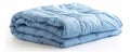 Folded light blue comforter on white background, cozy bedding concept Royalty Free Stock Photo