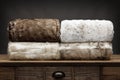 4 folded luxury fluffy throws shot on a wooden sideboard, with a grey background Royalty Free Stock Photo