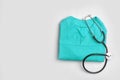Folded medical uniform with stethoscope and space f