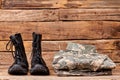 Folded military clothes and combat boots.