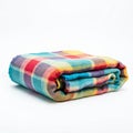 A folded multi-colored blanket featuring a checkered pattern with vibrant blue, red, Royalty Free Stock Photo