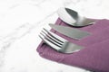 Folded napkin with fork, spoon and knife Royalty Free Stock Photo