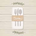 Folded napkin with twigs, cutlery and brown paper with the lettering word