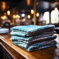 Folded napkins on a bar table in teal and brown