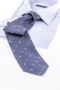 Folded new shirt and dark blue necktie on white Royalty Free Stock Photo