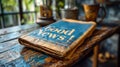 Folded newspaper with the headline Good News! on a wooden table, suggesting positive journalism, with a backdrop of books and Royalty Free Stock Photo