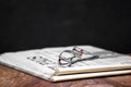 Folded newspaper with a pair of reading glasses on it Royalty Free Stock Photo