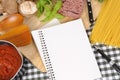 Folded recipe book with ingredients for Italian spaghetti bolognese, copy space Royalty Free Stock Photo