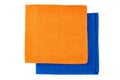 Folded orange and blue textile napkins on white