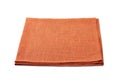 Folded orange textile napkin on white background Royalty Free Stock Photo