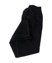 Folded pair of black denim pants isolated Royalty Free Stock Photo