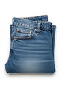 Folded pair of blue denim jeans on a white background. The jeans feature classic Royalty Free Stock Photo