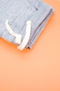 Denim cotton joggers with coulisse folded on an orange color table Royalty Free Stock Photo