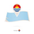 Folded paper map of Kiribati with flag pin of Kiribati