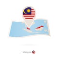 Folded paper map of Malaysia with flag pin of Malaysia Royalty Free Stock Photo