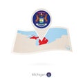 Folded paper map of Michigan U.S. State with flag pin of Michigan Royalty Free Stock Photo