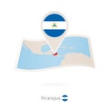 Folded paper map of Nicaragua with flag pin of Nicaragua Royalty Free Stock Photo