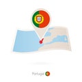 Folded paper map of Portugal with flag pin of Portugal Royalty Free Stock Photo