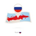 Folded paper map of Russia with flag pin of Russia Royalty Free Stock Photo