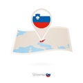 Folded paper map of Slovenia with flag pin of Slovenia Royalty Free Stock Photo