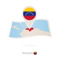 Folded paper map of Venezuela with flag pin of Venezuela Royalty Free Stock Photo