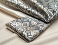 Folded patterned fabric on neutral background shows layered textures Royalty Free Stock Photo