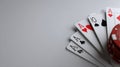 Folded Poker Hand With Multiple Aces and Chips on Neutral Background Showcasing Strategy and Anticipation in the Game Royalty Free Stock Photo