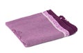 Folded purple linen towel on white background, top view