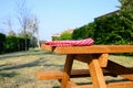 Folded red and white checkered tablecloth on wooden picnic table in backyard Royalty Free Stock Photo