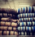 Folded rugs on sale in a store.