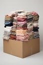 a folded stack of sweaters in pastel colors. Secondary clothing, reuse.