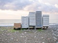 Folded sun loungers. End of season at the resort concept . The rest is over. Sunbeds stacked on top of each other. Business on Royalty Free Stock Photo