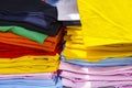 Folded t-shirts different colours. Sportswear in the store. fabrics