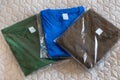 Folded t-shirts different colours. Sportswear in the store