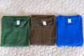 Folded t-shirts different colours. Sportswear in the store