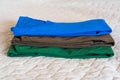 Folded t-shirts different colours. Sportswear in the store