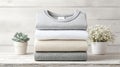 folded t-shirts hovering above surface, minimal clean white backdrop, fashion ecommerce style Royalty Free Stock Photo