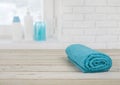 Folded towel on wooden planks over defocused brick wall window Royalty Free Stock Photo