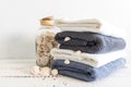 Folded towels near a bottle with seashells on a white wooden table. Spa and wellness, cotton terry textile. Ecological Royalty Free Stock Photo