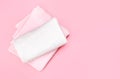 Folded towels on pink empty space background