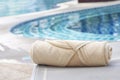 Folded towels are placed on a chair next to the pool. Royalty Free Stock Photo