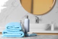 Folded towels and toiletries on marble table in bathroom Royalty Free Stock Photo