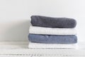 Folded towels on a white wooden table. Spa and wellness, cotton terry textile. Ecological theme Royalty Free Stock Photo