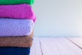 Folded towels on a wooden background. House cleaning. Space for your text