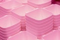 Folded pink transparent plastic containers.plastic bowls.Plastic food containers, baskets on the shelf in the store Royalty Free Stock Photo