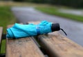 Folded umbrella on a bench