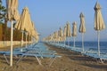 Folded umbrellas on the beach.