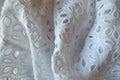 Folded white eyelet embroidery cotton fabric