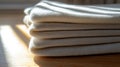 Folded white fabric on a wooden surface. Royalty Free Stock Photo