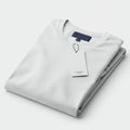 Folded white T-shirt with a round neck, placed on a flat surface. A rectangular, white Royalty Free Stock Photo